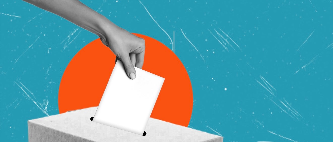 A hand places a blank ballot into a ballot box against a stylized background with a large orange circle and a blue, textured sky.