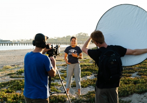 Three students shooting a video on the beach