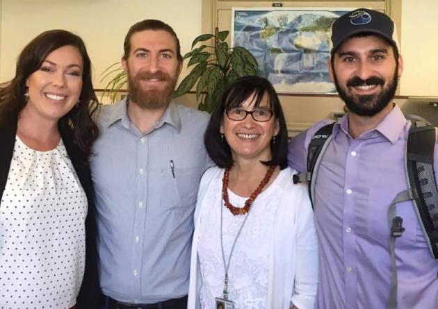 Four people standing together