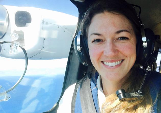 Smiling woman in plane passenger seat