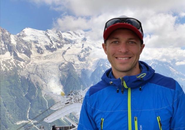 Ty Brandt in front of a snowy mountaintop