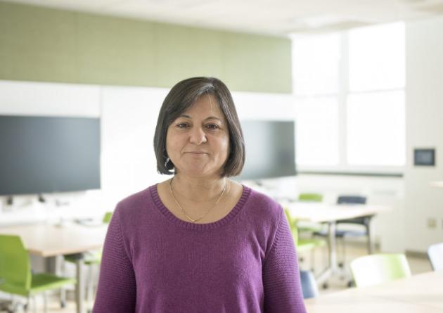 Madhu Khanna stands in a classroom