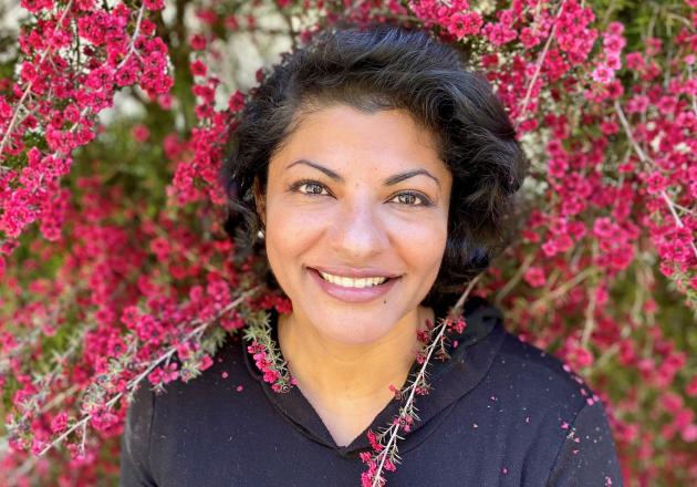 Woman standing among flower branches