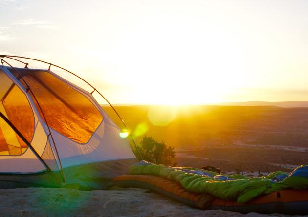 Tent perched on cliff overlooking national park