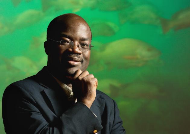 Rashid Sumaila in front of a green fish background