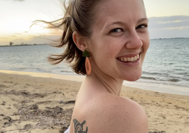 Caroline Ferguson stands on a beach