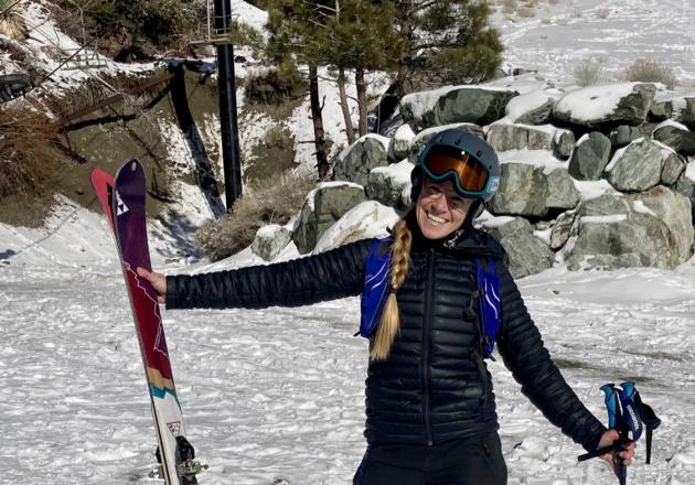 Laura Grant poses in ski gear on a snowy slope