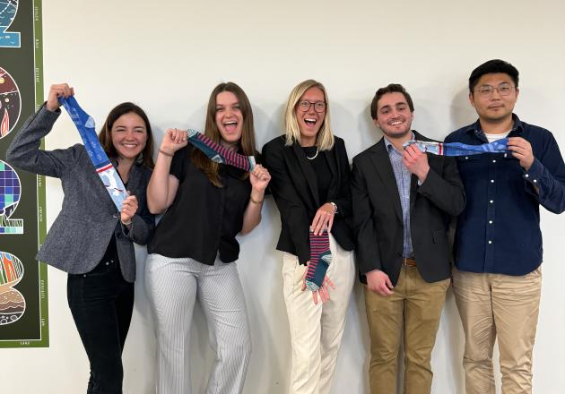 A group of students holds blue socks