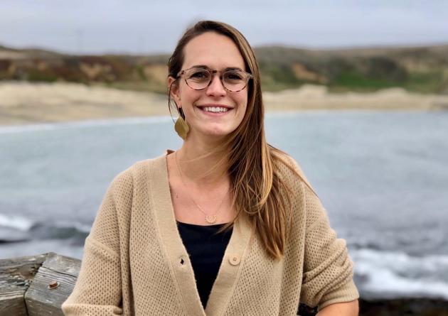 Melissa Ward stands in front of the ocean