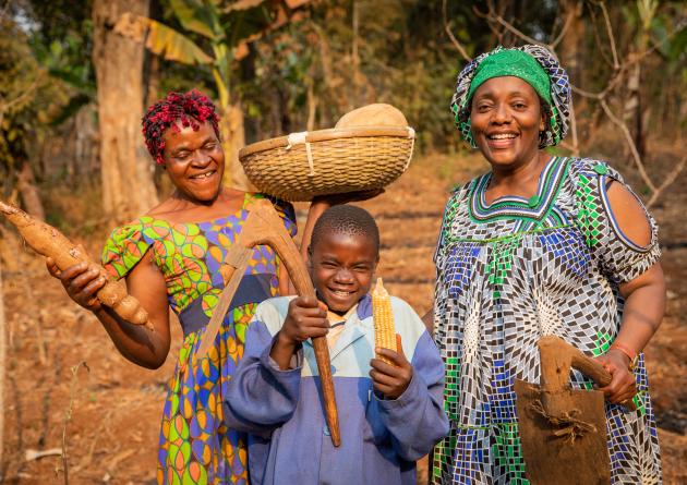 group of African farmers have fun in the fields, they have hoes in their hands