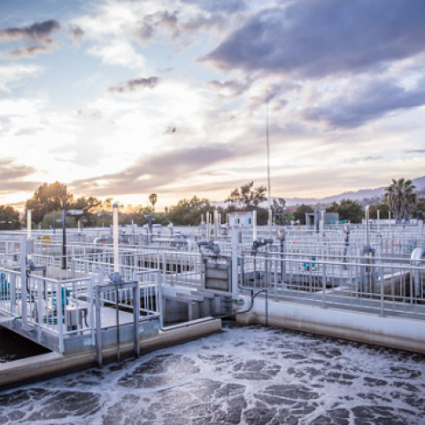 Sunset over wastewater treatment tanks