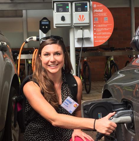 Woman charging an electric vehicle