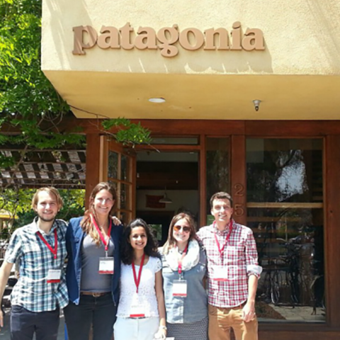 Five people stand together in front of Patagonia office front