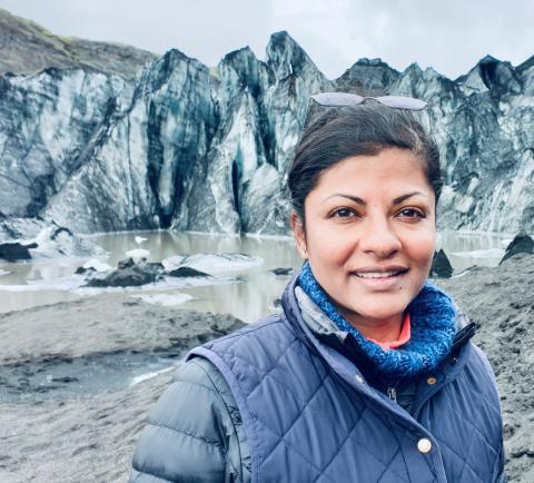 Woman standing near glacier in Iceland