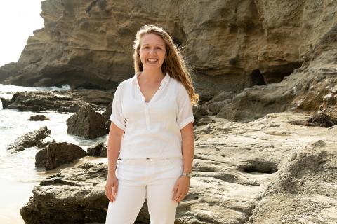 Woman standing on rocky shore