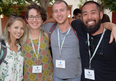 Four students smiling together