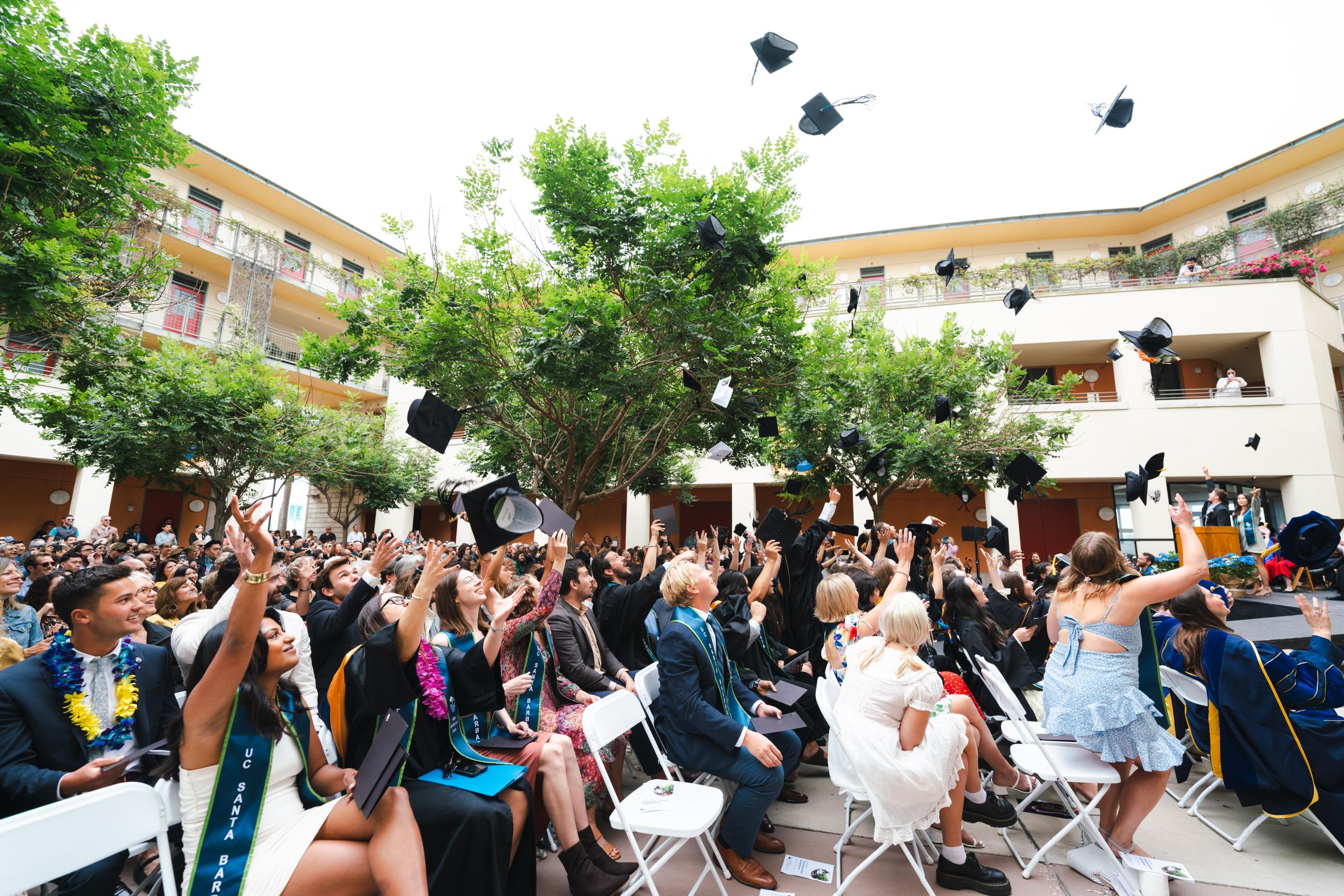 Graduates toss caps in the air