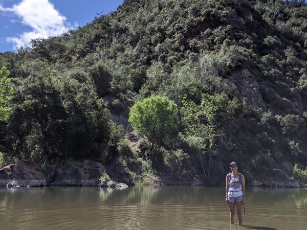 Woman standing in shallow river