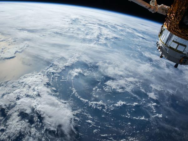 View of Earth from space with satellite