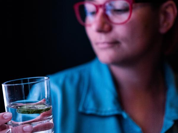 Woman holding glass of water