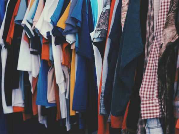 Colorful clothing hanging in a closet