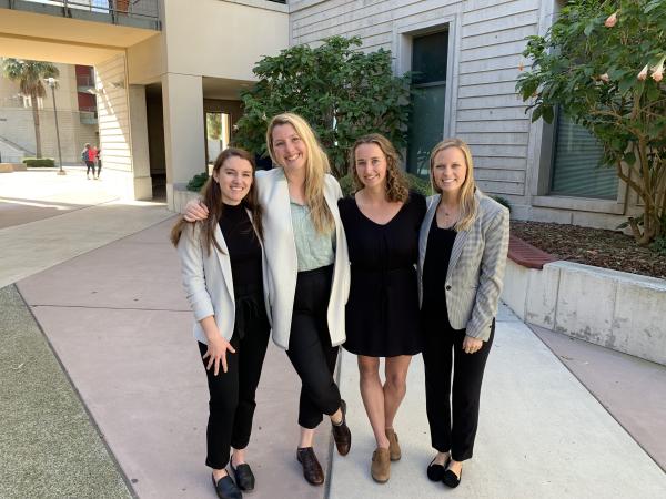 Group of four students smiling