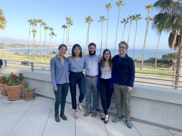 Five students stand together 