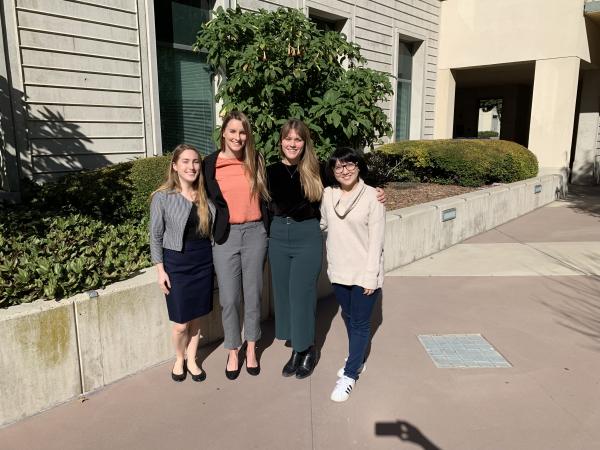 four students posing together