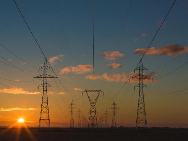 Sunset behind large electrical towers