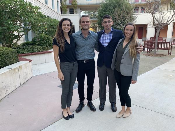 Group of four students smiling