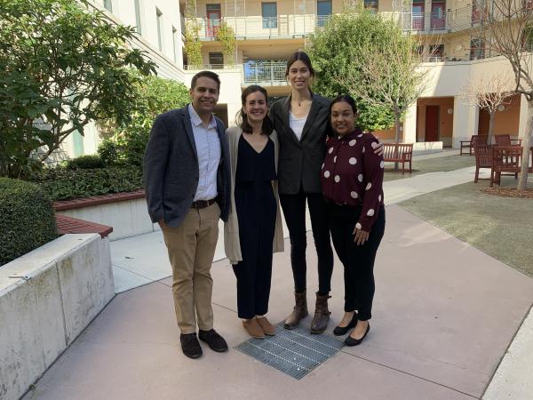 Group of four students smiling