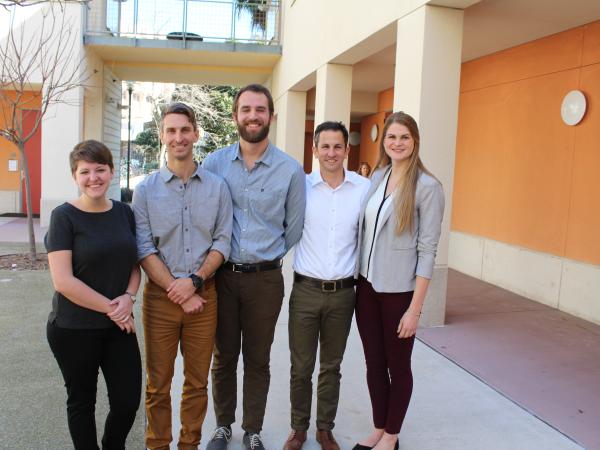 Group of five students posing together