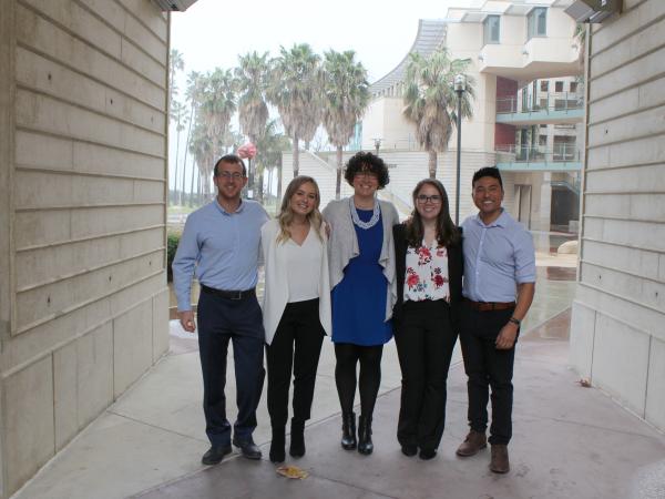 Five students posing together for a photo