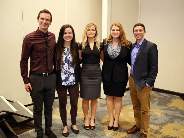 Group of five students posing together