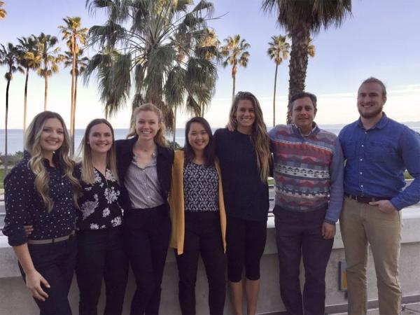 Seven people, students and professor posing for photo