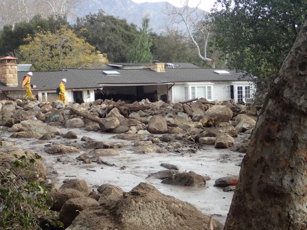 Mud and debris half burying a house 