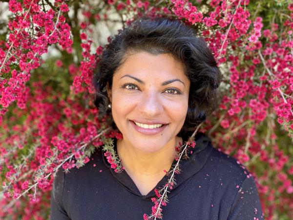 Woman standing among flower branches