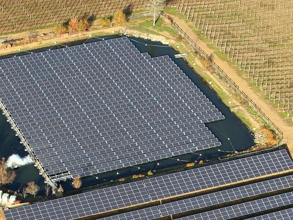 Aerial view of solar panels floating in pond