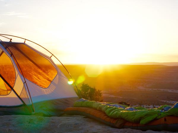 Tent perched on cliff overlooking national park