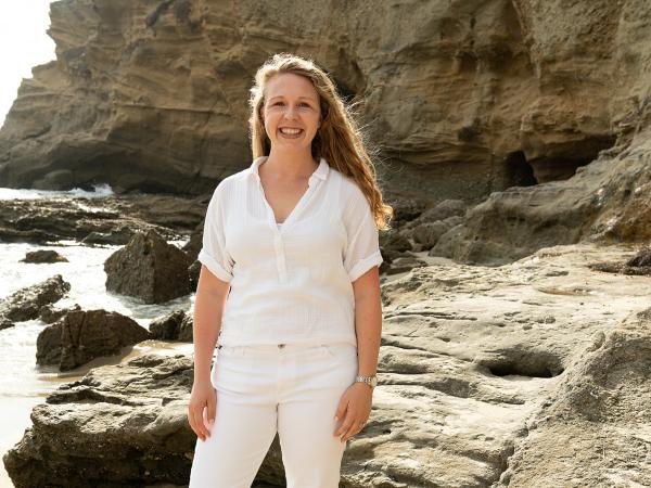 Woman standing on rocky shore