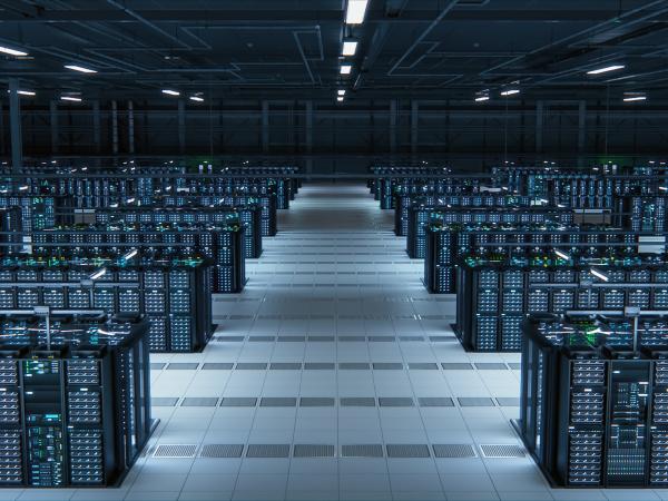 Many computer servers in a dark room in a data center 