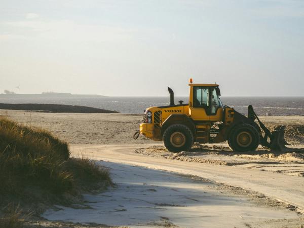 Yellow tractor on a sunny beach