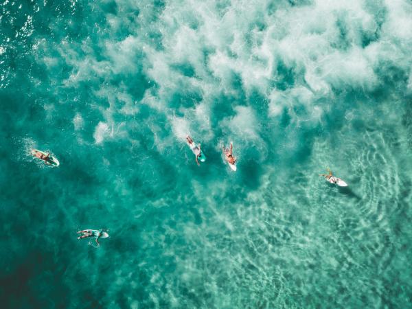 Drone shot of surfers in the water 